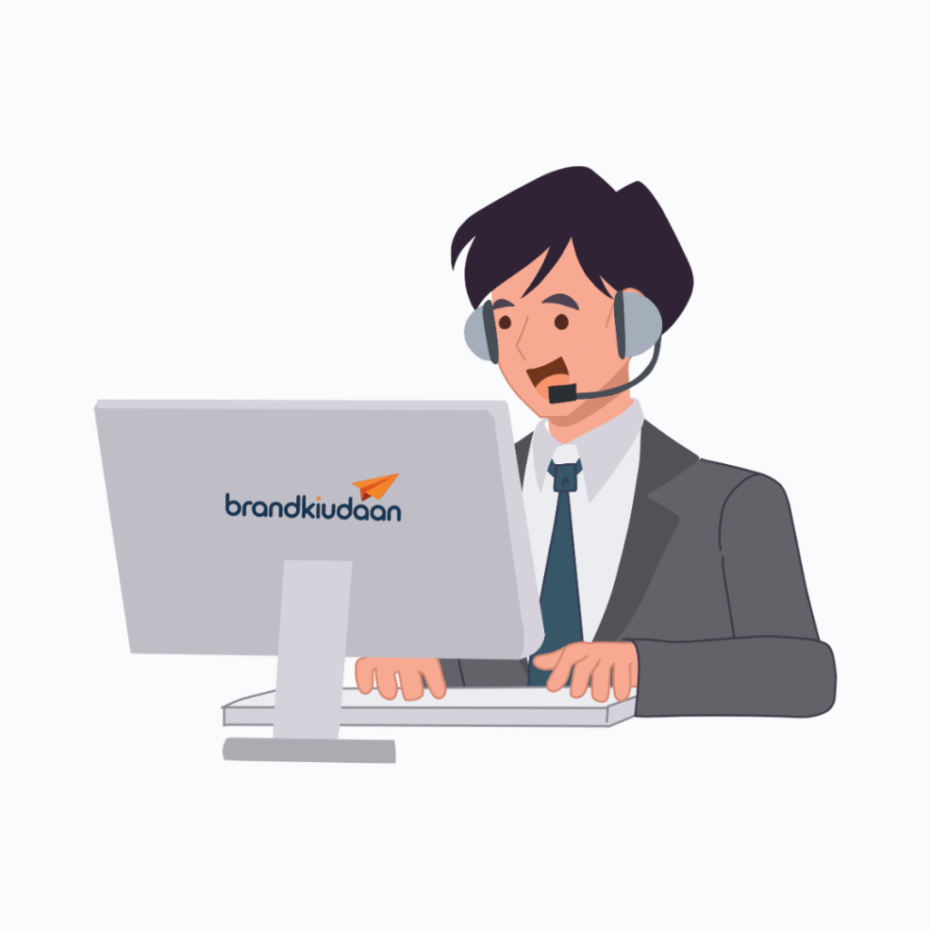 Customer support representative at Brand Ki Udaan providing assistance via computer.